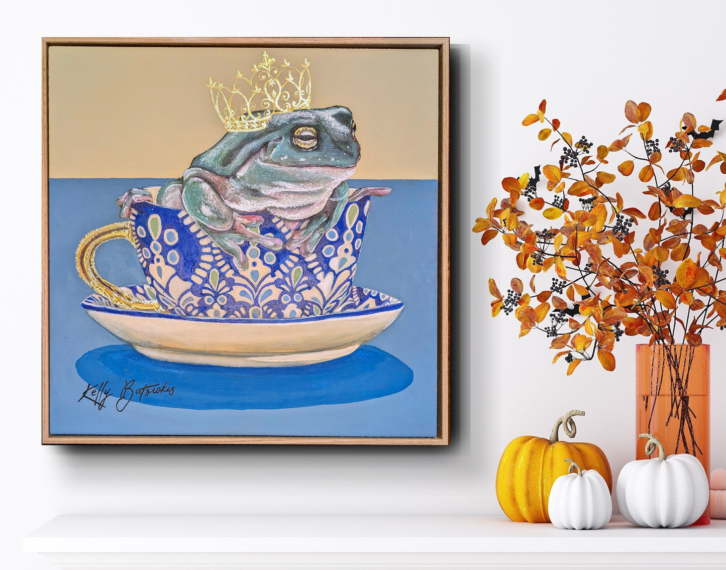 Green tree frog sitting in a patterned T2 teacup with a gold crown, from the Teaparty Series by Australian artist Kelly Batsiokis.