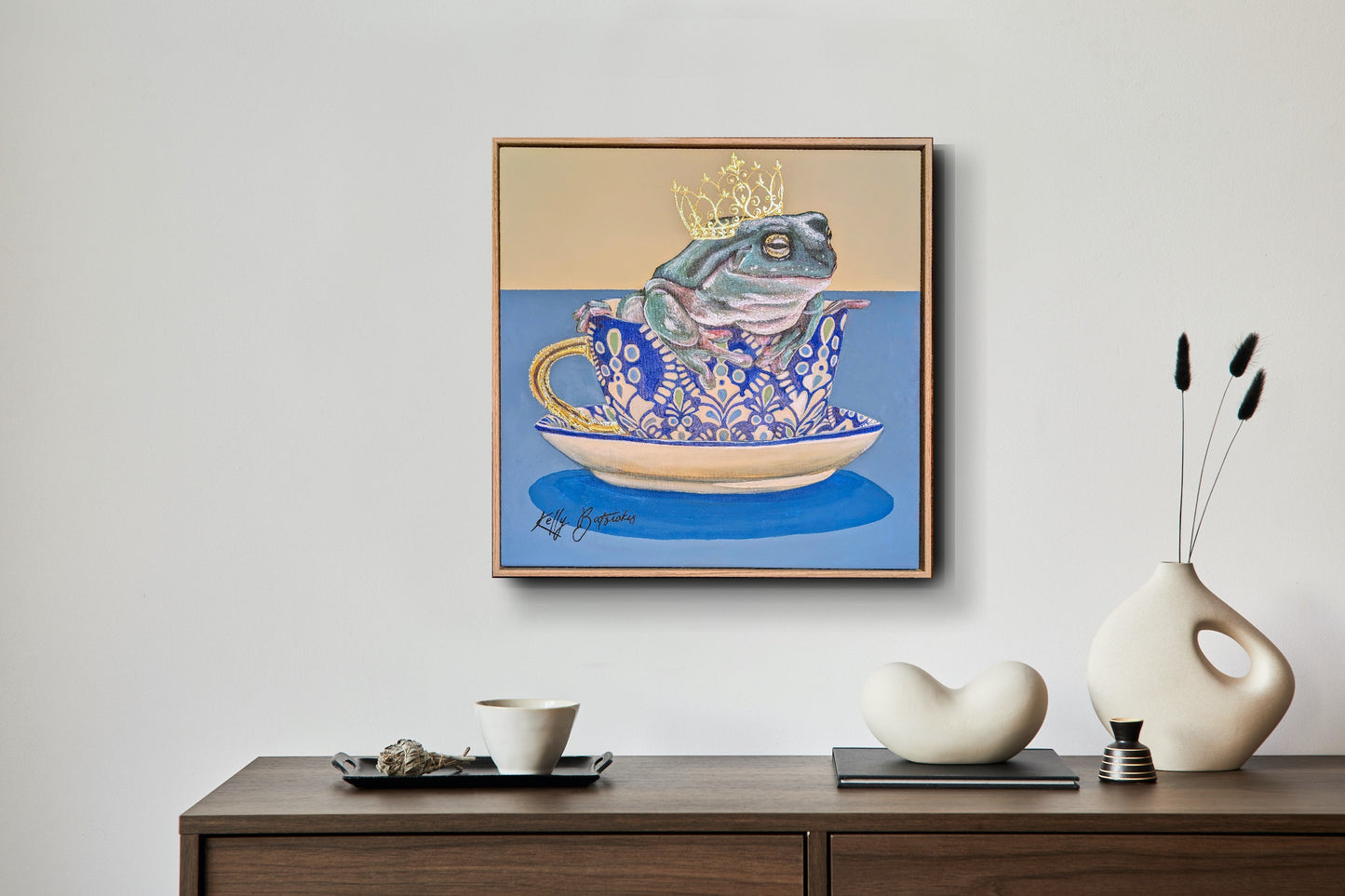 Green tree frog sitting in a patterned T2 teacup with a gold crown, from the Teaparty Series by Australian artist Kelly Batsiokis.