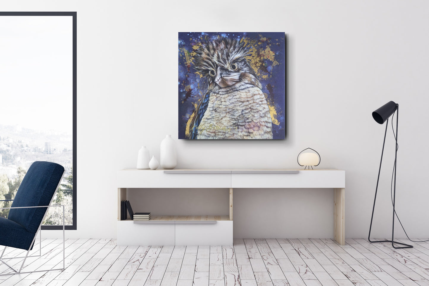 Modern interior with an embellished fine art print of Bazza the Kookaburra on a wall above a console table for scale. Please note the 91cm print is rolled and will require stretching for hanging/presentation. The print at this scale will also have a much smaller signature (a smaller version of the print has been used for illustrative scale purposes).