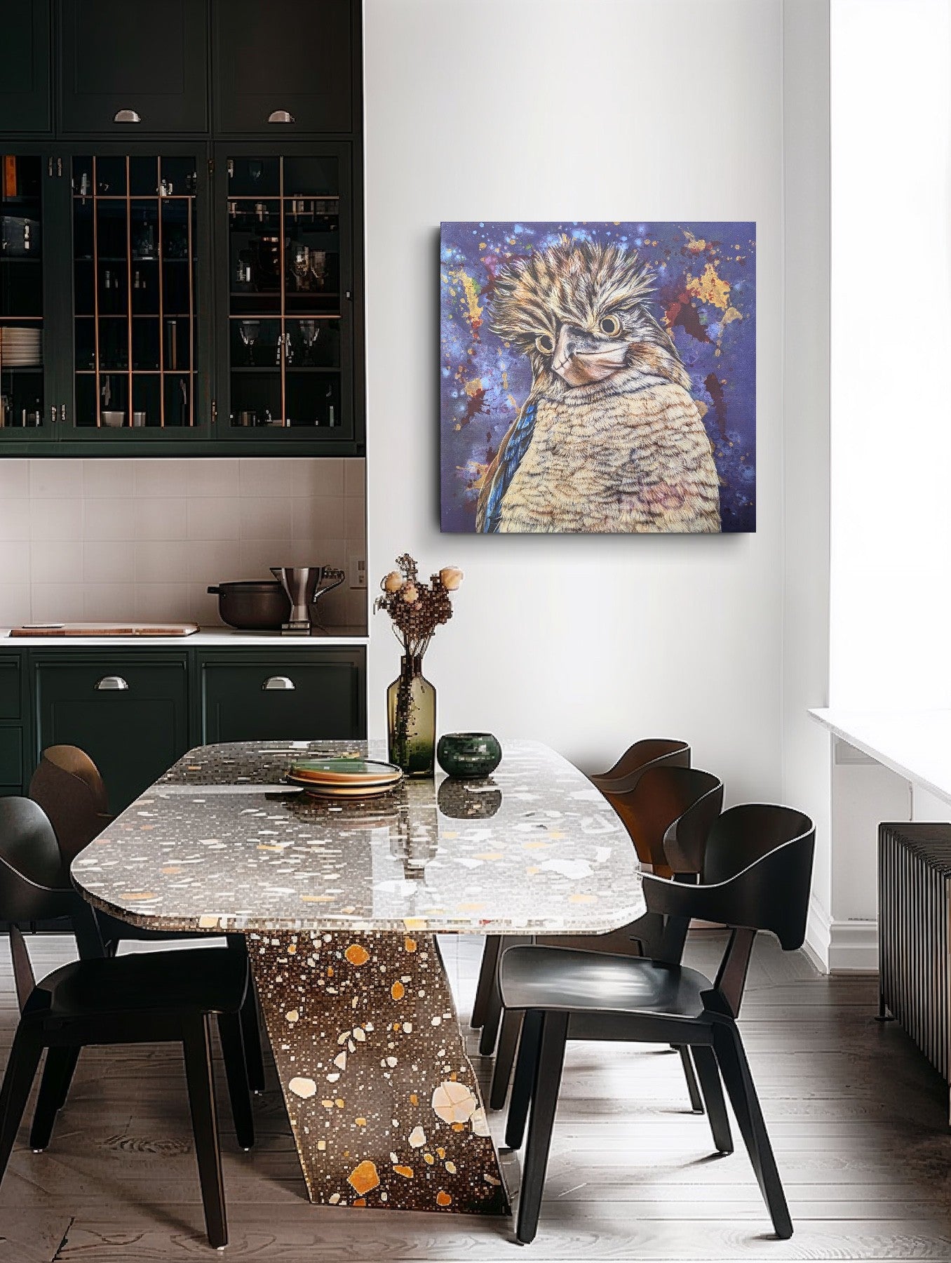 Dining area with a marble table and black chairs, featuring a unframed fine art print of Bazza the Kookaburra by Kelly Batsiokis on the wall or scale. Please note this print is posted rolled and will require streching for hanging/presentation.