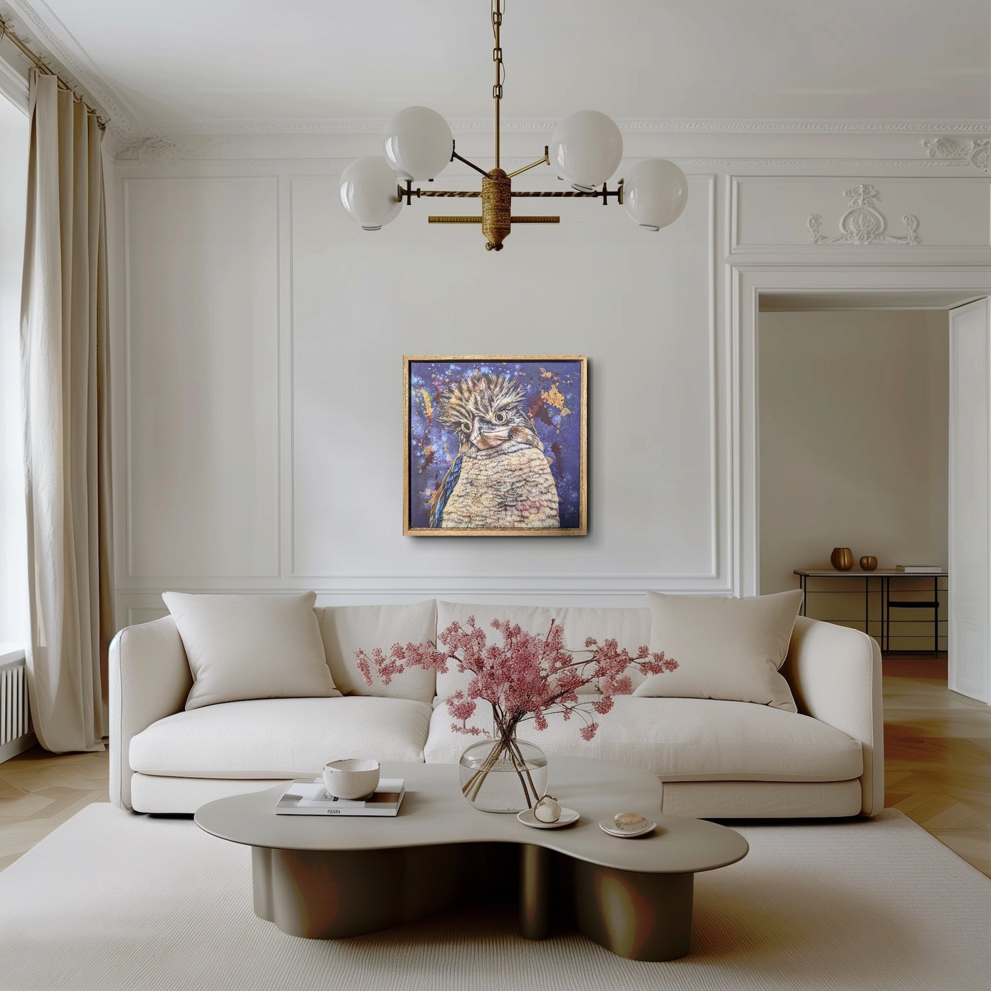 Modern living room with a white sofa, coffee table, and decorative elements and a framed fine art reproduction print of Bazza the Kookaburra by Kelly Batsiokis for scale.