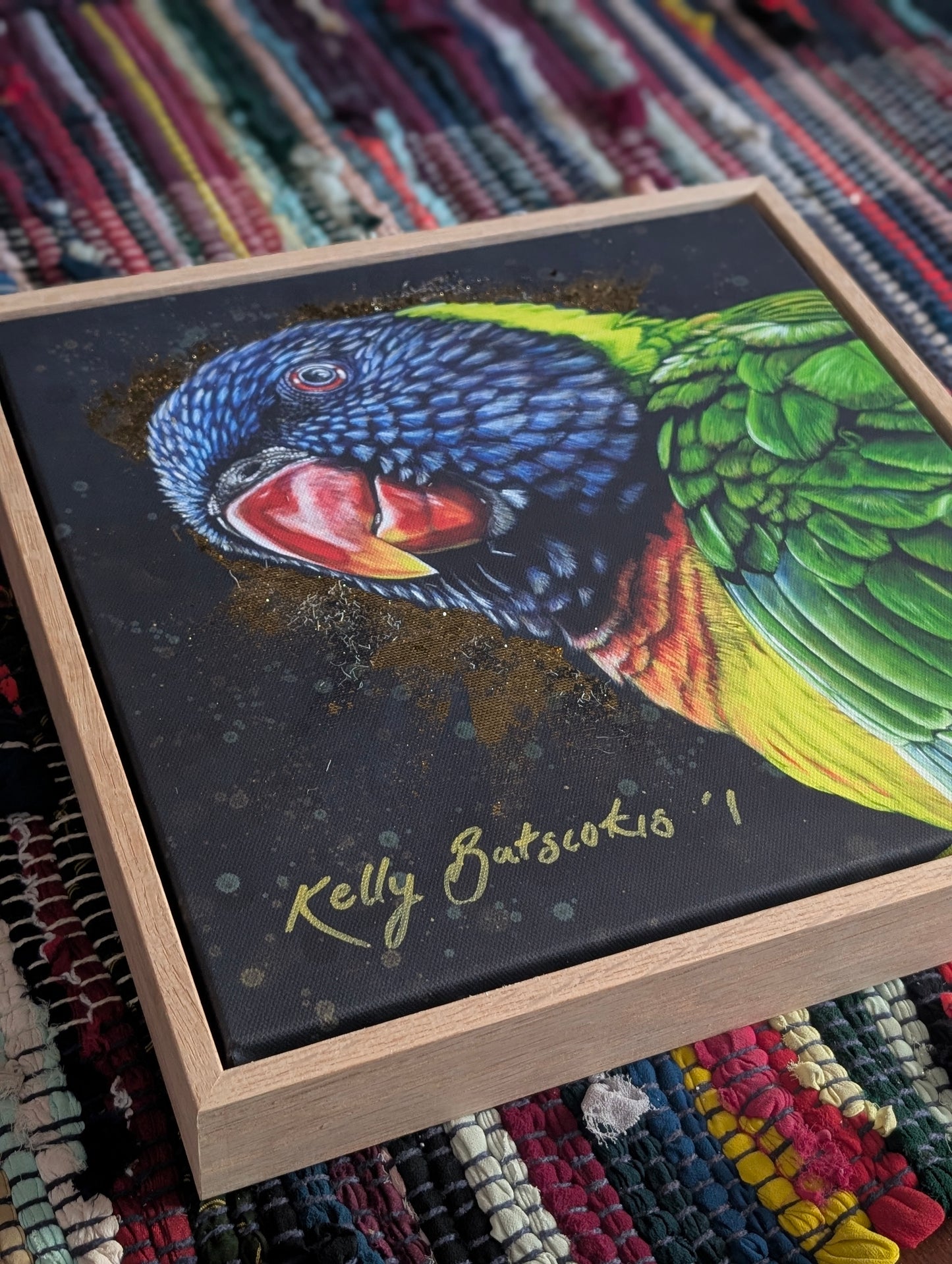 Framed embellished print of Shazza the Rainbow Lorikeet by Kelly Batsiokis showing the frame quality.